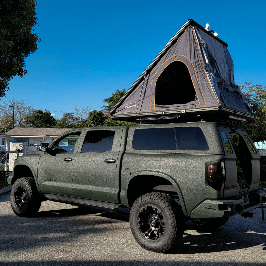 custom Devolro Toyota Tundra with a tent on topper